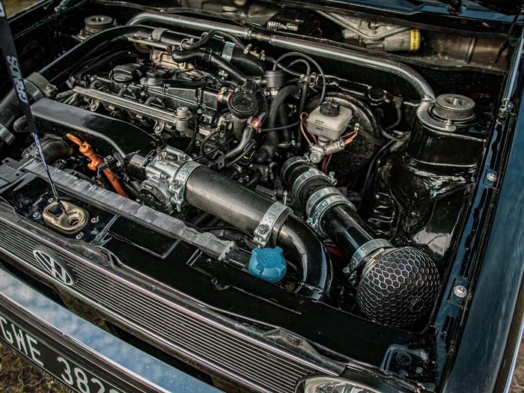 Close up of a car engine under an open hood