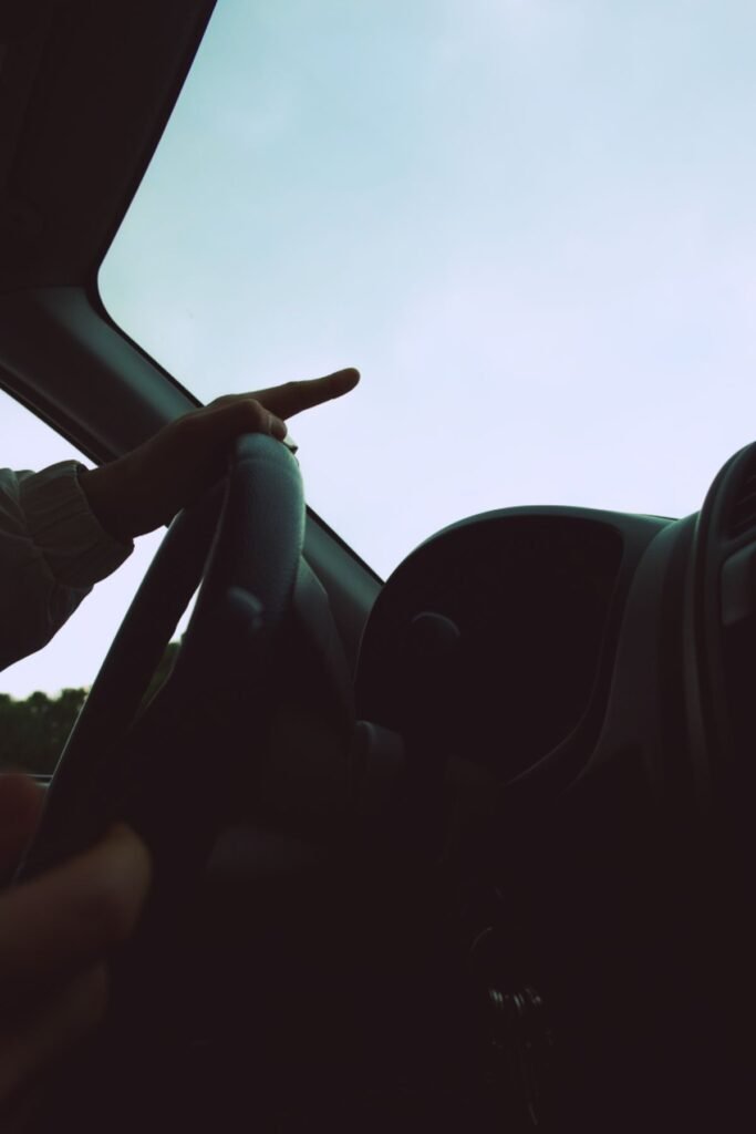 Driver point of view over the steering wheel and dashboard while driving a car