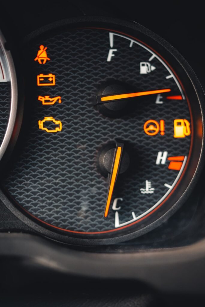 Close up of a car dashboard with several warning lights glowing