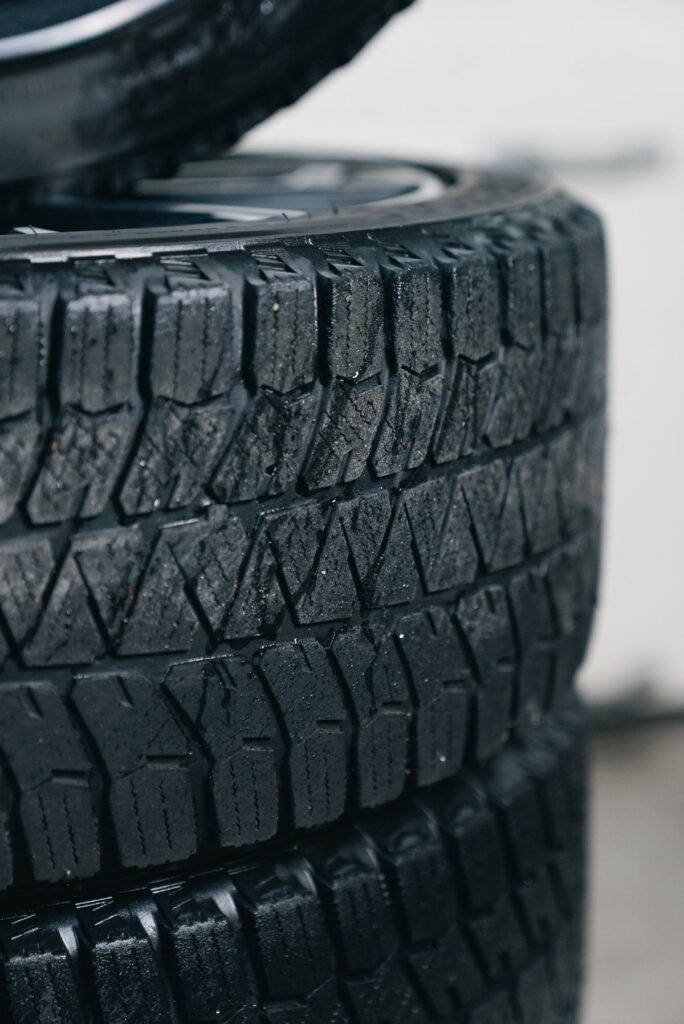 Close up of stacked car tires showing detailed tread patterns