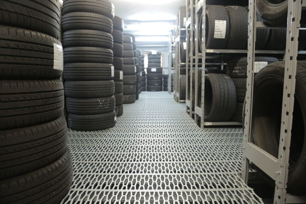 Rows of new tires stacked in a tire shop warehouse