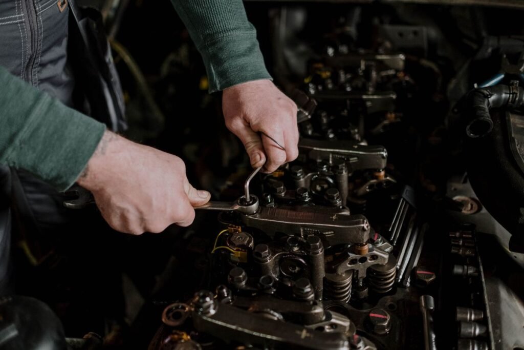 Close up of a mechanic using hand tools to work on a car engine